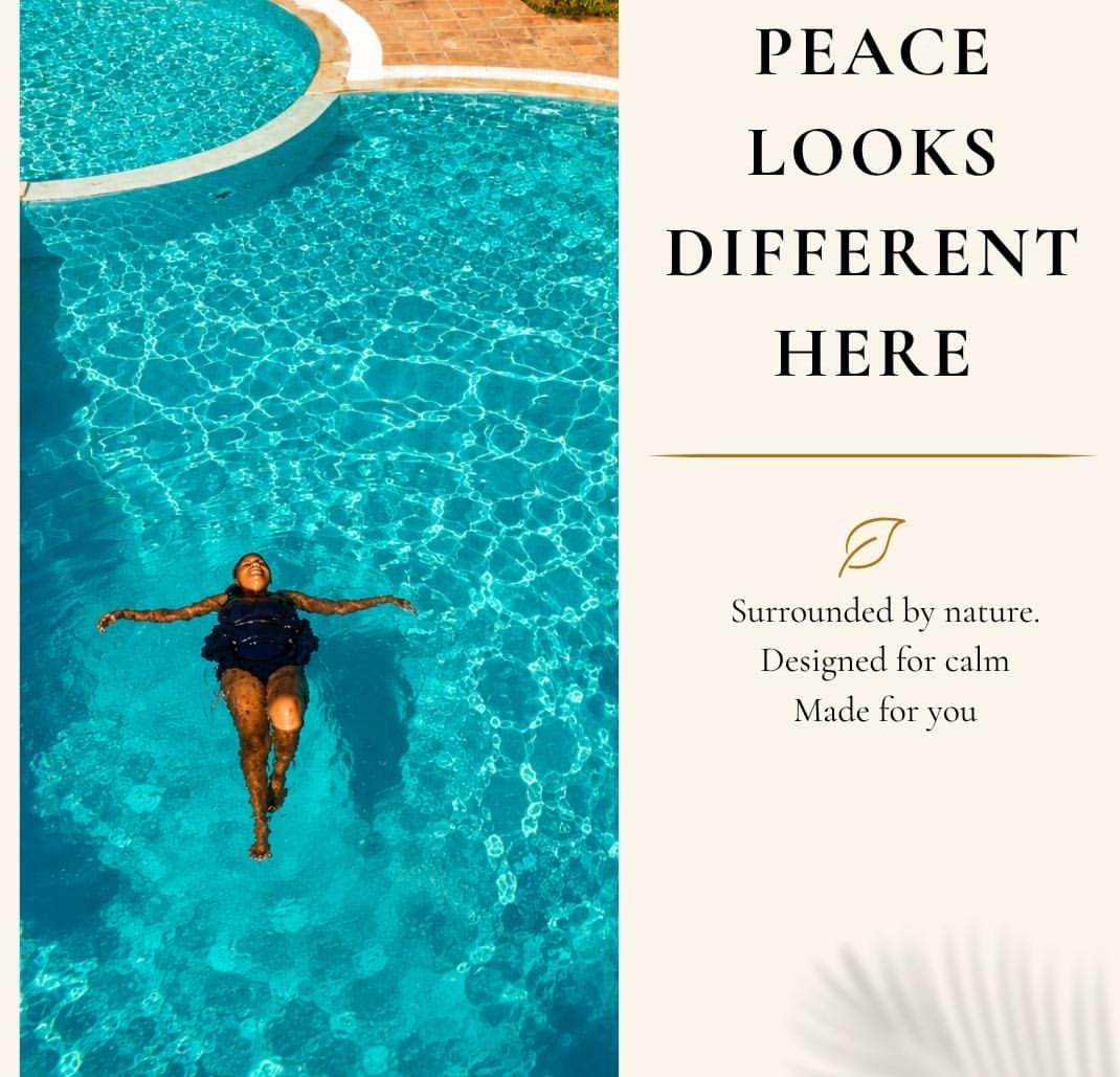 Guest floating in the turquoise swimming pool at Tumaini Gardens