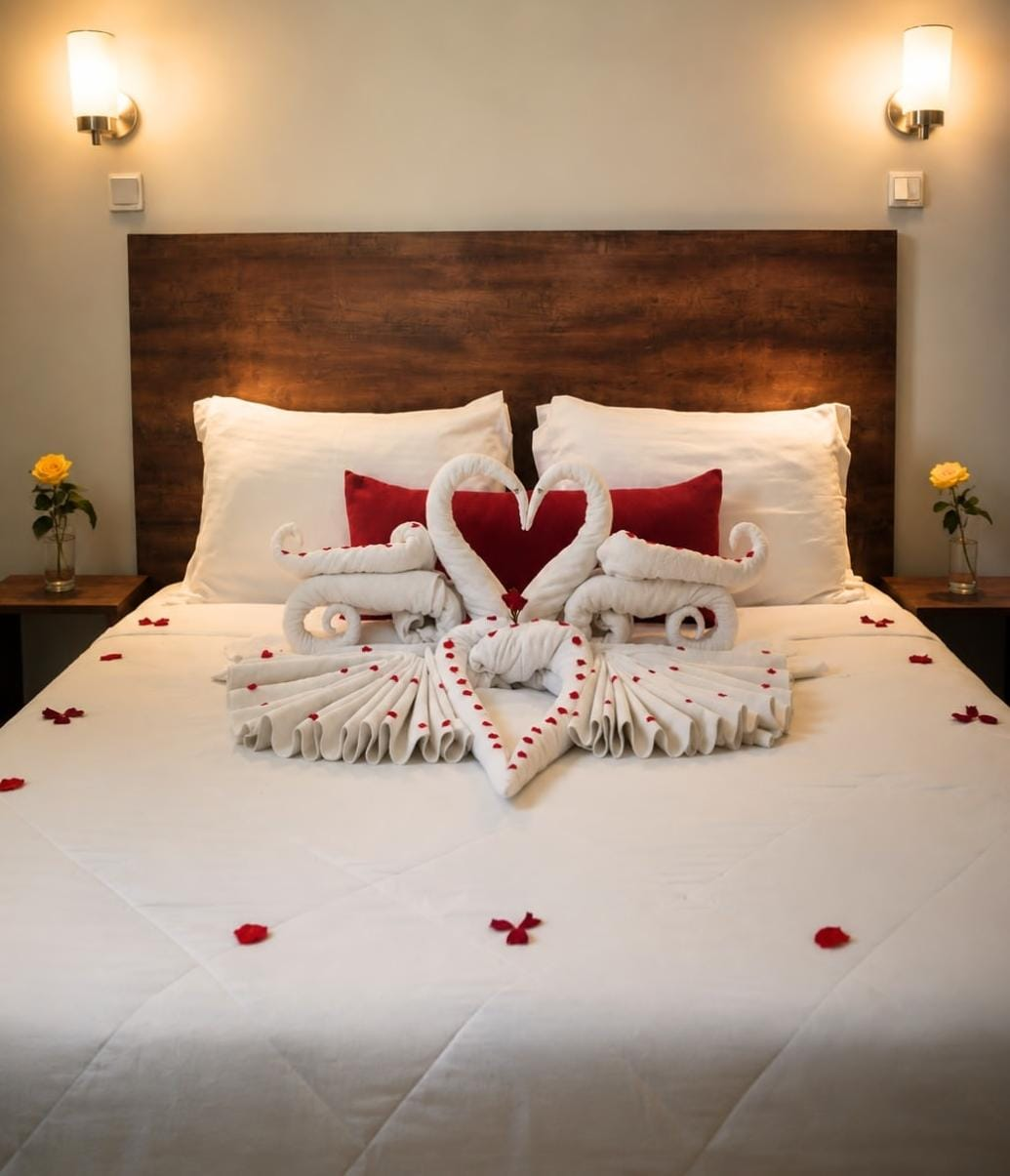 Honeymoon room with swan towel art and rose petals